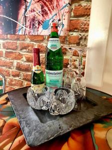 two bottles and glasses sitting on a table at Kunst am Rothaarsteig in Brilon Centrum in Brilon