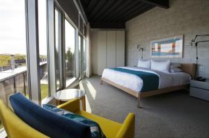 a hotel room with a bed and a balcony at 250 Main Hotel in Rockland