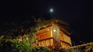 a house at night with the moon in the sky at Sea Hut Homestay in Cochin