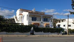 a white house on the side of a street at Vale do Sol in Albufeira