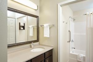 a bathroom with a sink and a mirror at Staybridge Suites Glenview, an IHG Hotel in Glenview