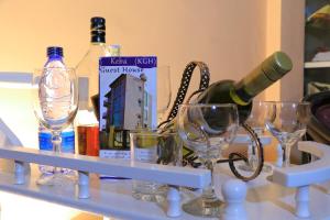 a shelf with wine bottles and glasses on it at Keba Guesthouse in Addis Ababa