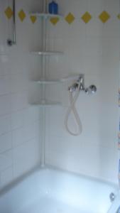 a shower with a faucet in a bathroom at Pension Sonnenschein in Schmallenberg
