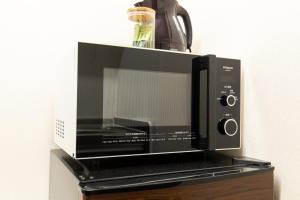 a microwave oven sitting on top of a table at YUFU-INN - FUJI SUITE- Vacation STAY 95235 in Yufuin