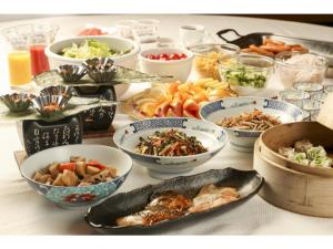 a table with many bowls of food on it at Hotel Grand Vert Gizan - Vacation STAY 95367 in Gifu