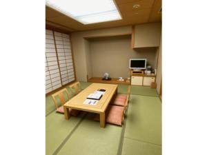 a room with a table and chairs and a television at Hotel Grand Vert Gizan - Vacation STAY 95369 in Gifu