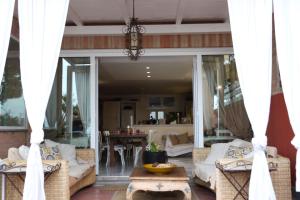 a screened in porch with couches and a table at B&B La Casa di Era in Porto San Giorgio