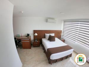 Hotel Caquetá Real HSC客房内的一张或多张床位