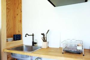 a kitchen with a sink and a counter at New Art Building - Vacation STAY 95699 in Tokyo