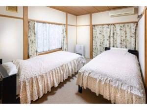 Pension Eastmountain Hakuba - Vacation STAY 95920 tesisinde bir odada yatak veya yataklar