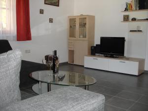 a living room with a coffee table and a tv at Haus Telisia in Klösterle am Arlberg