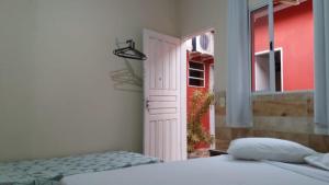 a bedroom with a bed and an open door at Ao Mare in São Francisco