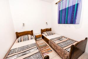 Postel nebo postele na pokoji v ubytování Apartments Goldie