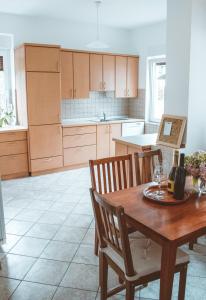 a kitchen with a wooden table and wooden chairs at Entoli Apartment in Podnanos
