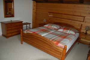 a bedroom with a wooden bed and a dresser at Landhaus St. Rupert in Bad Hofgastein