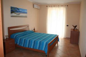 a bedroom with a bed and a large window at Gaia Holidays in Cefalù