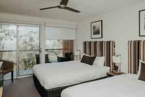 a hotel room with two beds and a window at Mercure Clear Mountain Lodge in Mount Samson