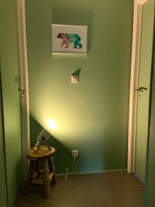 a hallway with a table and a picture on the wall at Ancienne maison rénovée au calme in Wanze