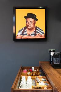 a painting of a man with a hat on a wall at Windsorian Experience in Windsor