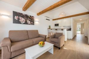 a living room with a couch and a table at Camelina Suites in San Antonio Bay