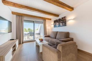 a living room with a couch and a table at Camelina Suites in San Antonio Bay