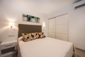 a bedroom with a white bed and a white closet at Camelina Suites in San Antonio Bay