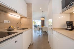 a kitchen with white cabinets and a counter top at Camelina Suites in San Antonio Bay