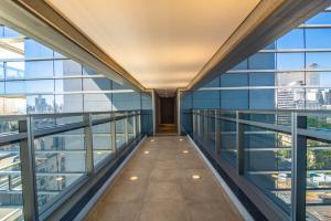 einen leeren Flur in einem Gebäude mit Glasfenstern in der Unterkunft 360 República in São Paulo