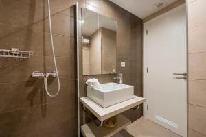a bathroom with a sink and a shower at Camelina Suites in San Antonio Bay