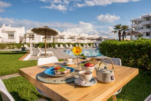 a wooden table with a tray of food on it at Camelina Suites in San Antonio Bay