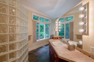 a bathroom with two sinks and a large glass wall at Pigeon Creek Inn - Adults Only in Holland +23 photos