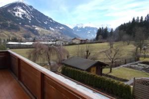 a balcony with a view of a field and mountains at Landhaus St. Rupert in Bad Hofgastein