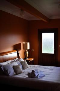 a bedroom with a large bed with a window at The George at Yering in Yering