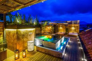 a backyard with a swimming pool at night at Múbú Hotel Boutique in Valle de Bravo