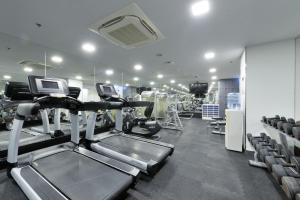 a gym with treadmills and machines in a room at Hotel Royal Bangkok@Chinatown in Bangkok