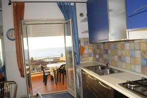 a kitchen with a view of the ocean at IKEA in Piraino