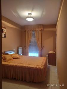 a bedroom with a large bed and a window at TU CASA EN MEQUINENZA CON WIFI in Mequinenza