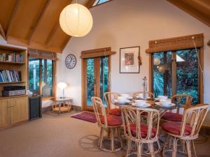 a dining room with a table and chairs at Evergreen Haven - Queenstown Holiday Home in Queenstown