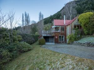 a house with a red roof on a hill at Evergreen Haven - Queenstown Holiday Home in Queenstown