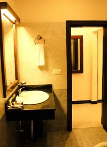 a bathroom with a sink and a mirror at Hotel One DG Khan in Taunsa