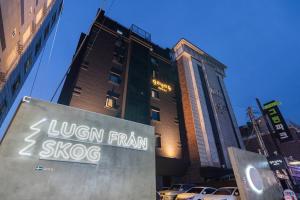 a sign in front of a tall building at Goyo37 Hotel Osan by Anook in Osan