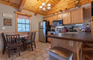 a kitchen with a table and chairs and a refrigerator at Ozarks Oasis cabin in Branson