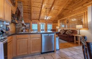 a kitchen with a sink and a stove in a cabin at Ozarks Oasis cabin in Branson
