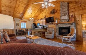 a living room with a couch and a fireplace at Ozarks Oasis cabin in Branson