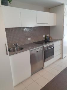 A kitchen or kitchenette at Glenelg Seaside Apartment - Free Car Park