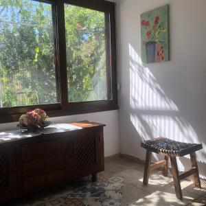 a room with a chair and a desk and a window at Galaria House in Moutoullas