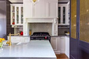 a kitchen with white cabinets and a stove at The Regents Park in Maitland