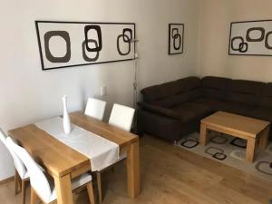 a living room with a table and a couch at Amazing City center apartment with balcony in Moravská Ostrava +3 photos