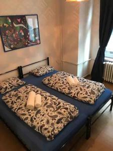 two twin beds in a bedroom with a leopard print at Amazing City center apartment with balcony in Moravská Ostrava
