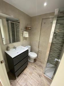 a bathroom with a toilet and a sink and a shower at For a Stay DMS III in Salou